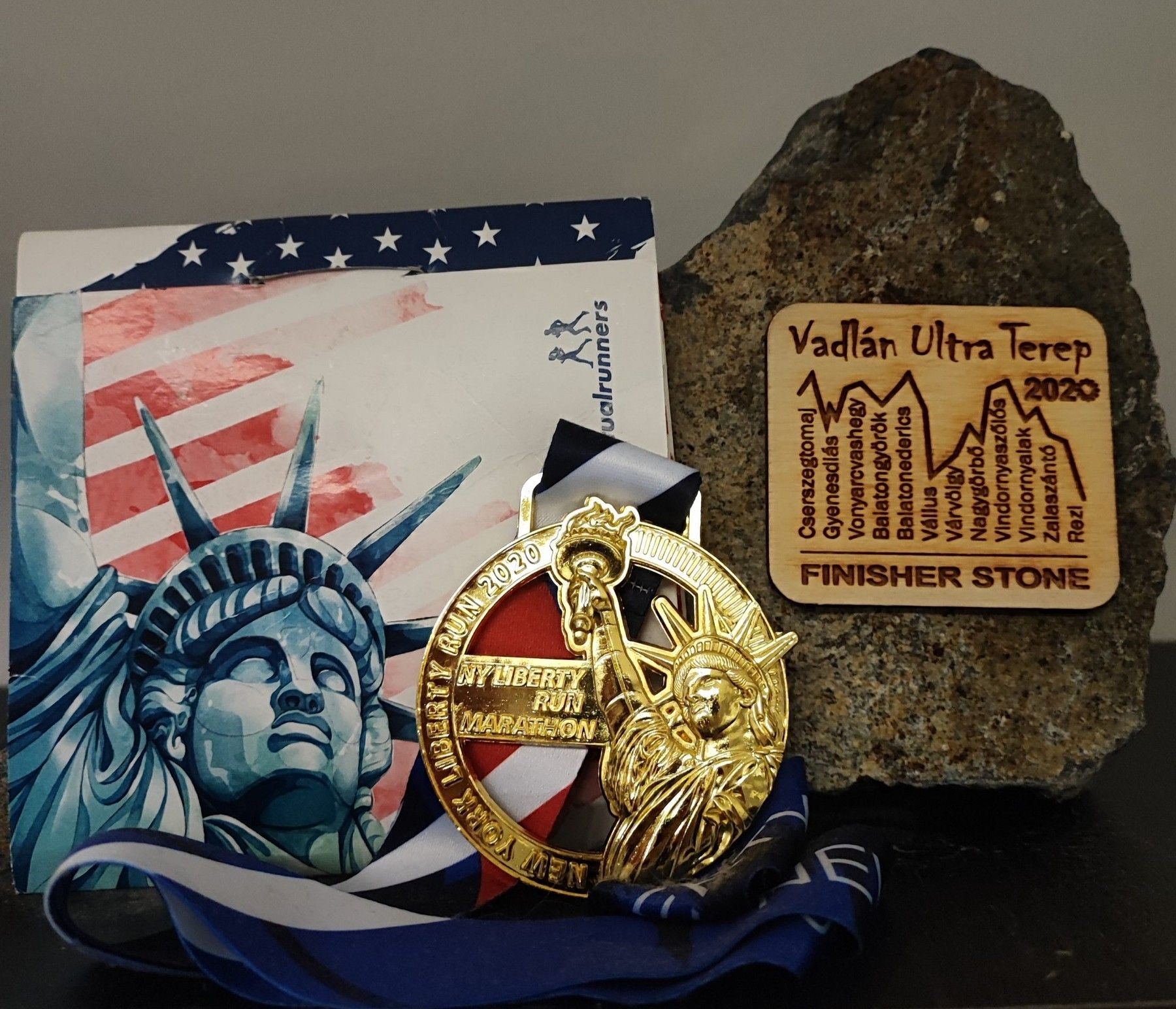 Norbert befutóérmei: a NY Liberty Run maraton érme és a Vadlán Ultra Terep kövéből készült díj